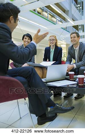 Business people having meeting in office building View Large Photo Image Stock Photograph - Business people having meeting in office building. Fotosearch