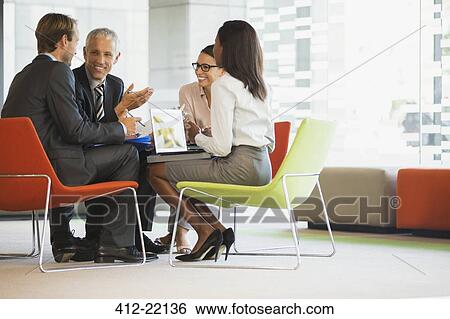 Stock Photograph - Business people having meeting in office building. Fotosearch