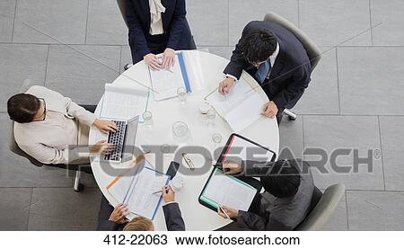 Stock Image - Business people meeting at table . Fotosearch