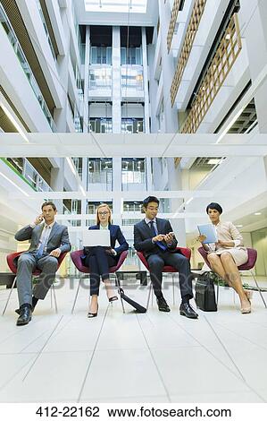 Business people sitting in office building View Large Photo Image Stock Image - Business people sitting in office building. Fotosearch