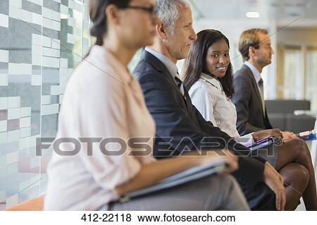 Business people sitting in office together View Large Photo Image Stock Photo - Business people sitting in office together. Fotosearch