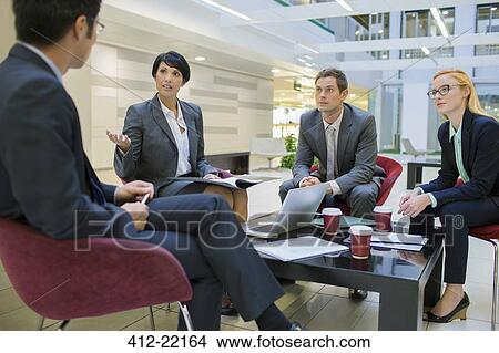 Picture - Business people talking in meeting in office building. Fotosearch