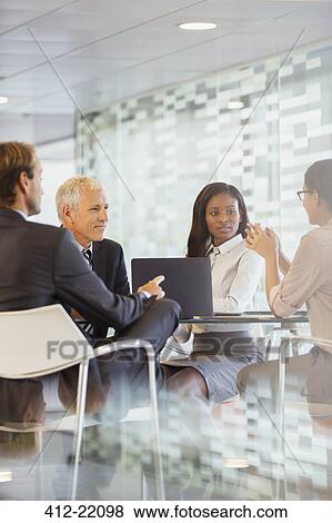 Business people talking in meeting in office building View Large Photo Image Stock Photo - Business people talking in meeting in office building. Fotosearch