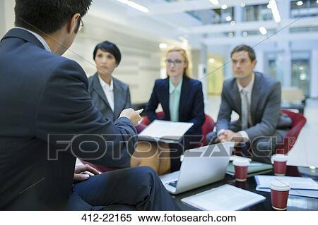 Stock Photography - Business people talking in meeting in office building. Fotosearch