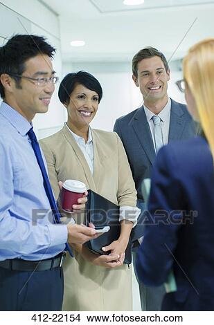 Business people talking in office building View Large Photo Image Picture - Business people talking in office building. Fotosearch