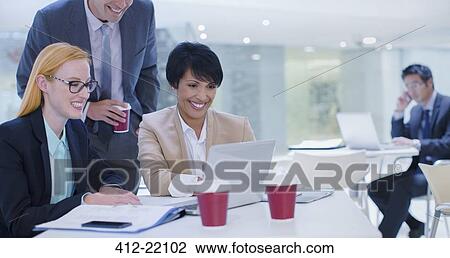 Business people working on laptop at table View Large Photo Image Stock Image - Business people working on laptop at table. Fotosearch