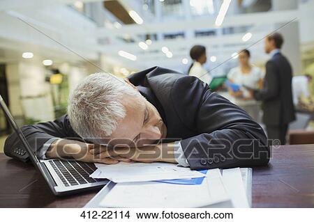 Businessman resting in office building View Large Photo Image Picture - Businessman resting in office building. Fotosearch