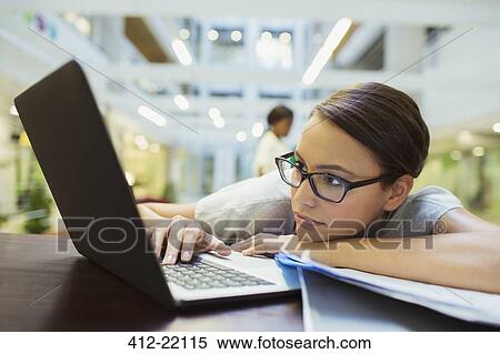 Businesswoman relaxing with laptop in office building View Large Photo Image Stock Photography - Businesswoman relaxing with laptop in office building. Fotosearch