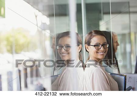 Businesswoman standing in office building View Large Photo Image Stock Image - Businesswoman standing in office building. Fotosearch