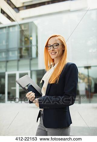 Businesswoman walking outside of office building View Large Photo Image Stock Image - Businesswoman walking outside of office building. Fotosearch