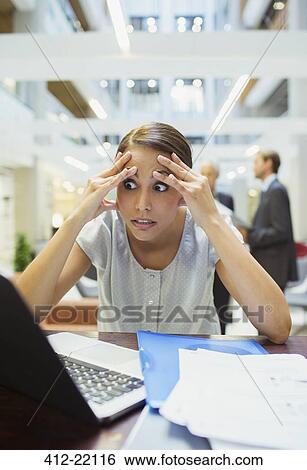 Stressed businesswoman working in office building View Large Photo Image Stock Photograph - Stressed businesswoman working in office building. Fotosearch