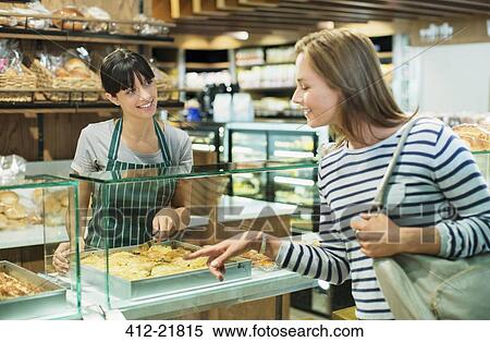 Clerk serving customer at deli counter in grocery store View Large Photo Image Stock Photography - Clerk serving customer at deli counter in grocery store. Fotosearch