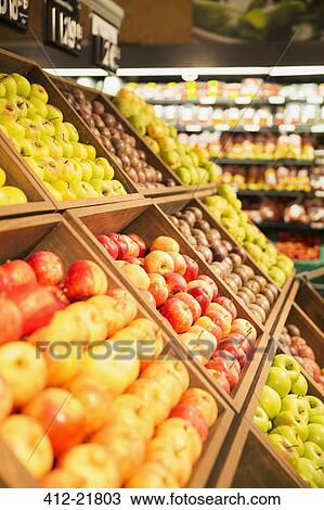 Stock Image - Close up of fruit in produce section of grocery store. Fotosearch