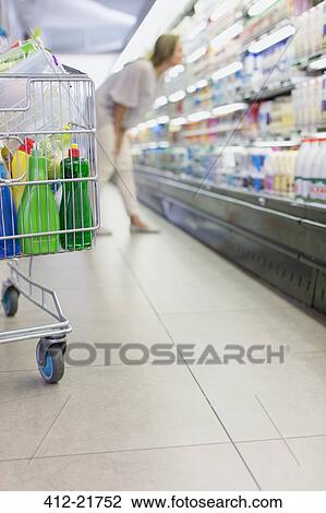 Close up of full shopping cart in grocery store View Large Photo Image Stock Image - Close up of full shopping cart in grocery store. Fotosearch