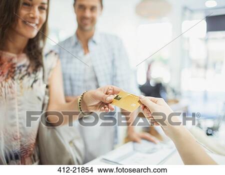Close up of woman paying with credit card in store View Large Photo Image Picture - Close up of woman paying with credit card in store. Fotosearch