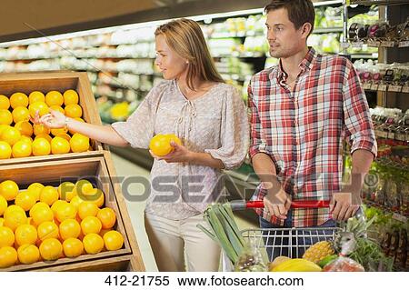 Couple shopping together in grocery store View Large Photo Image Stock Photography - Couple shopping together in grocery store. Fotosearch
