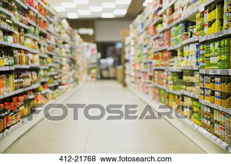 Defocussed view of grocery store aisle View Large Photo Image Stock Photo - Defocussed view of grocery store aisle. Fotosearch
