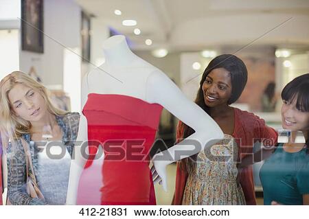 Women shopping together in clothing store View Large Photo Image Stock Image - Women shopping together in clothing store. Fotosearch