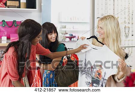 Women shopping together in clothing store View Large Photo Image Stock Photo - Women shopping together in clothing store. Fotosearch