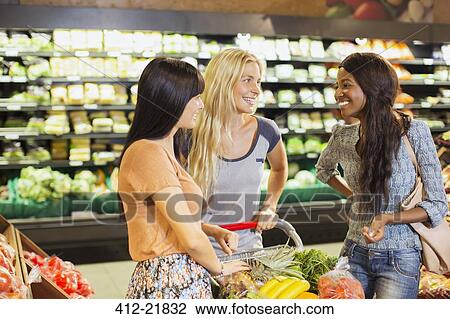 Women shopping together in grocery store View Large Photo Image Stock Image - Women shopping together in grocery store. Fotosearch