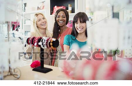 Picture - Women shopping together in store. Fotosearch