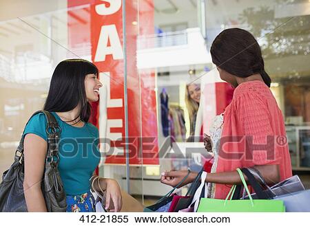 Stock Photography - Women window shopping together in shopping mall. Fotosearch