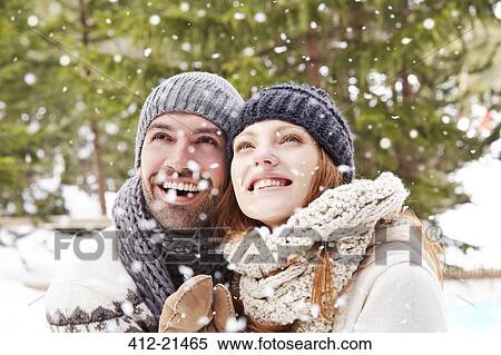 Couple admiring the snow together View Large Photo Image Stock Photography - Couple admiring the snow together. Fotosearch
