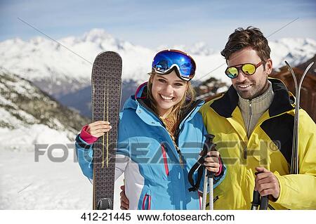 Couple carrying skis on mountain top View Large Photo Image Stock Photography - Couple carrying skis on mountain top . Fotosearch