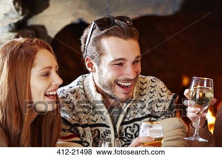 Couple enjoying drinks with friends View Large Photo Image Stock Photo - Couple enjoying drinks with friends. Fotosearch