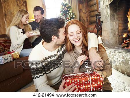 Picture - Couple exchanging gifts on Christmas. Fotosearch