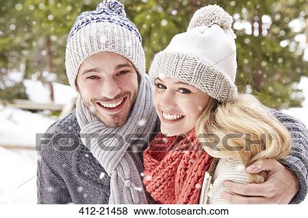 Couple hugging in the snow View Large Photo Image Stock Photo - Couple hugging in the snow. Fotosearch