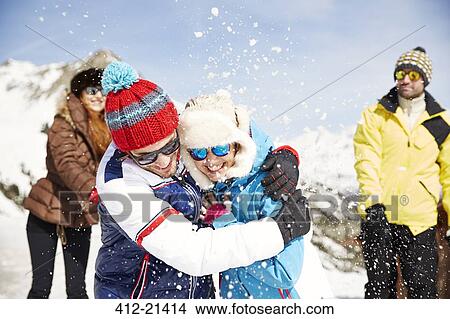 Couple playing in snow together View Large Photo Image Picture - Couple playing in snow together. Fotosearch