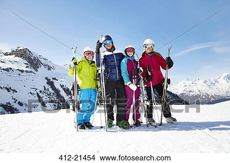 Family carrying skis on mountain top View Large Photo Image Picture - Family carrying skis on mountain top. Fotosearch