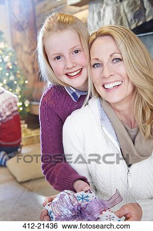 Stock Photograph - Family exchanging gifts on Christmas. Fotosearch