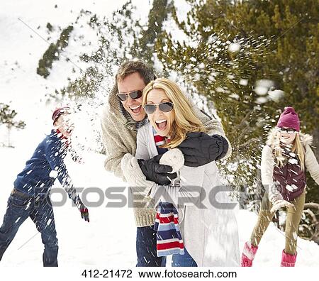 Family having a snowball fight in the snow View Large Photo Image Stock Image - Family having a snowball fight in the snow. Fotosearch