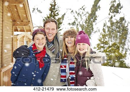 Family hugging in the snow View Large Photo Image Stock Photo - Family hugging in the snow. Fotosearch