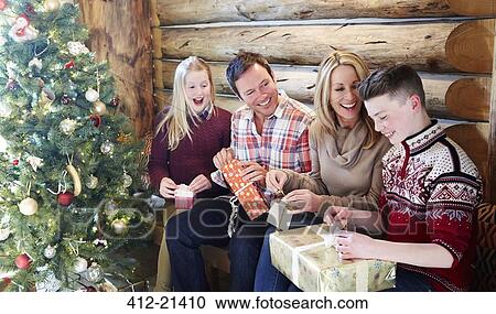 Stock Image - Family opening gifts on Christmas. Fotosearch