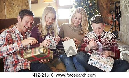Stock Image - Family opening gifts on Christmas. Fotosearch