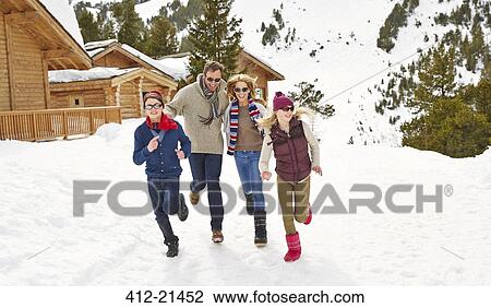 Family running in the snow together View Large Photo Image Stock Image - Family running in the snow together. Fotosearch