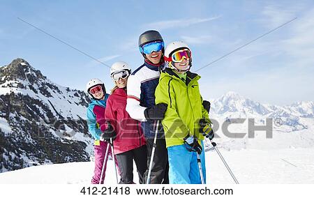 Stock Photo - Family skiing on mountain top. Fotosearch