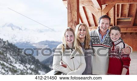 Stock Image - Family smiling on balcony together. Fotosearch