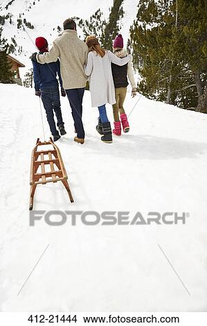 Family walking in snow together View Large Photo Image Picture - Family walking in snow together. Fotosearch