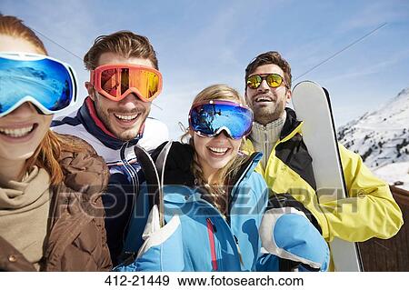 Friends carrying skis on mountain top View Large Photo Image Stock Photo - Friends carrying skis on mountain top. Fotosearch