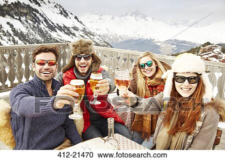 Friends celebrating with drinks in the snow View Large Photo Image Stock Image - Friends celebrating with drinks in the snow. Fotosearch
