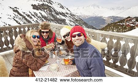 Friends enjoying drinks together View Large Photo Image Stock Image - Friends enjoying drinks together. Fotosearch