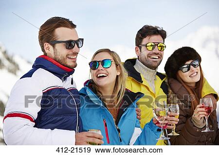 Stock Photo - Friends enjoying drinks together. Fotosearch