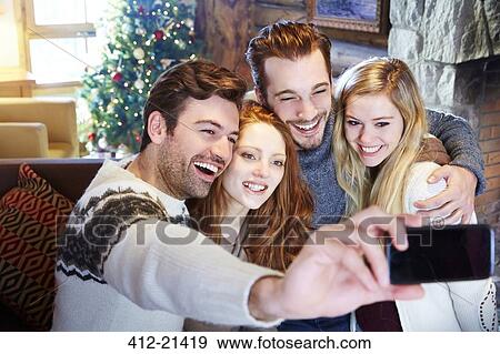 Friends taking picture together in log cabin View Large Photo Image Stock Photo - Friends taking picture together in log cabin. Fotosearch