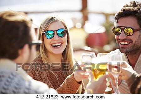 Friends toasting each other with wine View Large Photo Image Stock Image - Friends toasting each other with wine. Fotosearch