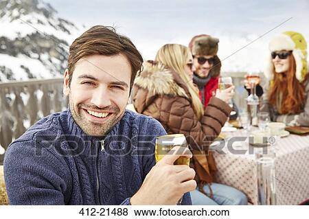 Man enjoying drinks with friends View Large Photo Image Stock Photo - Man enjoying drinks with friends. Fotosearch