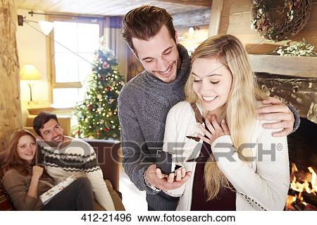 Man giving girlfriend jewelry for Christmas View Large Photo Image Stock Photograph - Man giving girlfriend jewelry for Christmas. Fotosearch